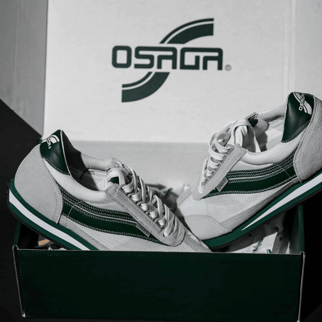 White and green sneakers in a shoe box with Osaga logo.