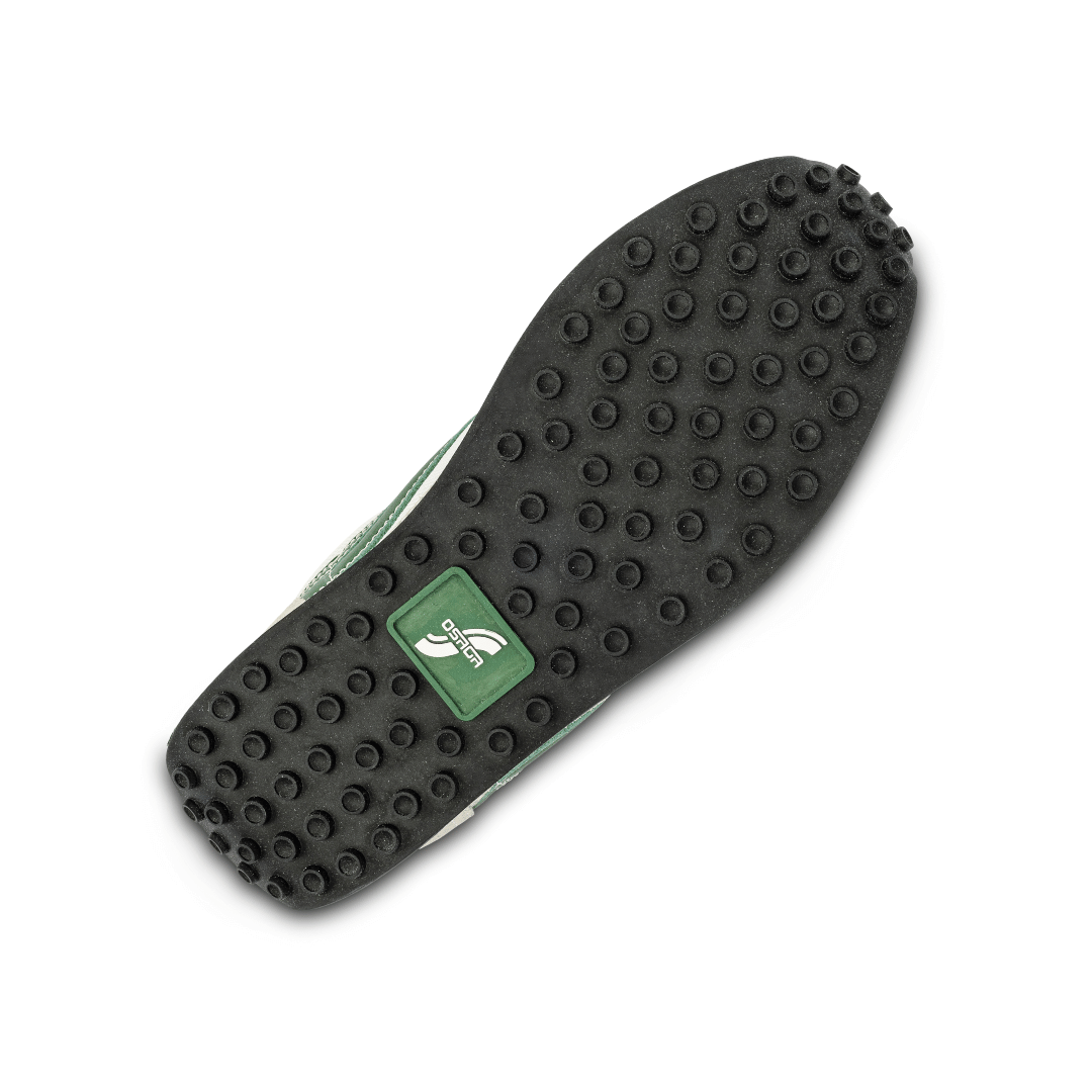 Close-up of a black shoe sole with a osaga brand logo on a white background